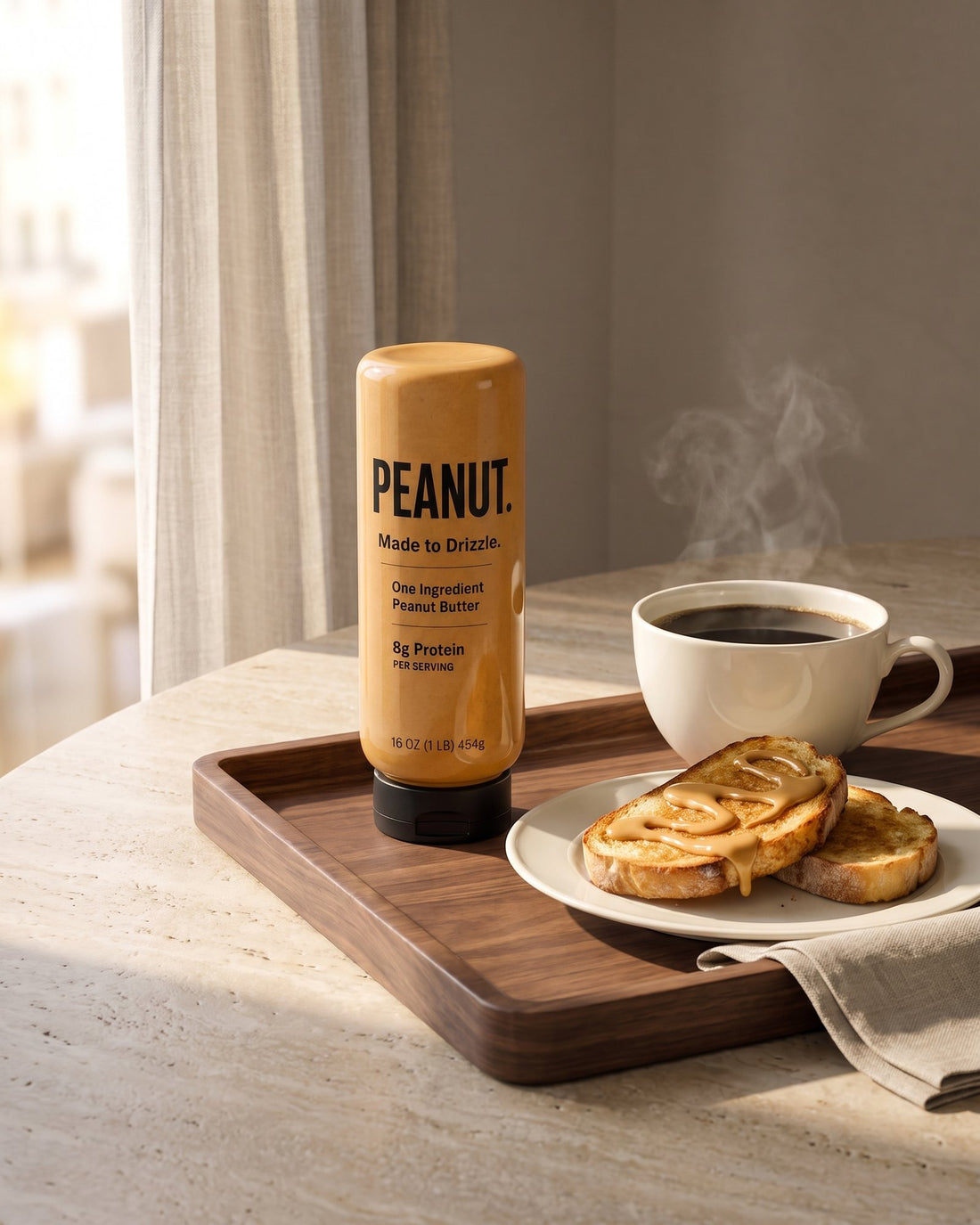 The bottle on a breakfast tray with a cup of coffee and toast spread with peanut butter